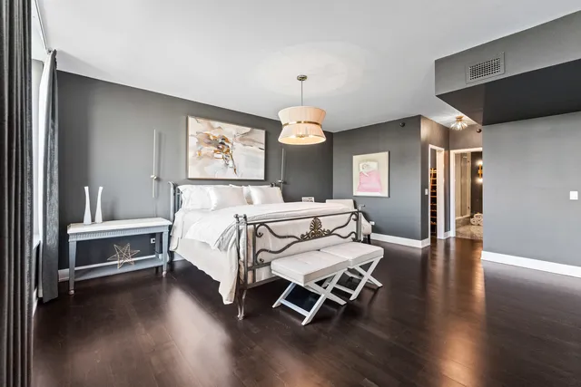 a bed room with a bed and a chandelier