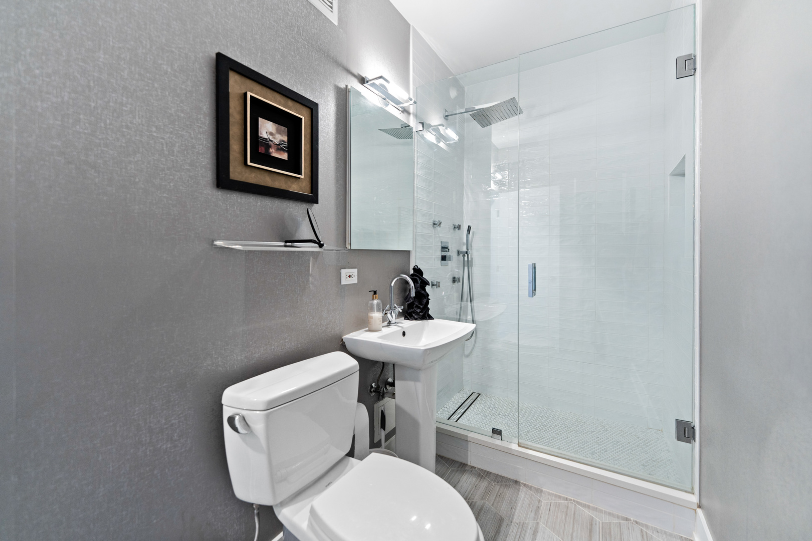 55 West Delaware Place, Unit 1011 Chicago, IL 60610 - Photo 39 of 50 a bathroom with a toilet a sink and a mirror