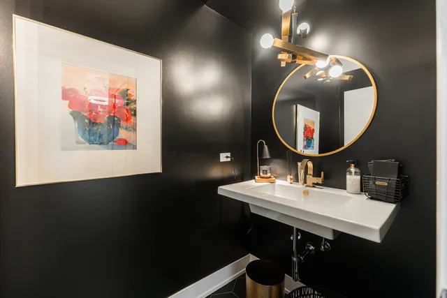 a bathroom with a sink mirror and vanity