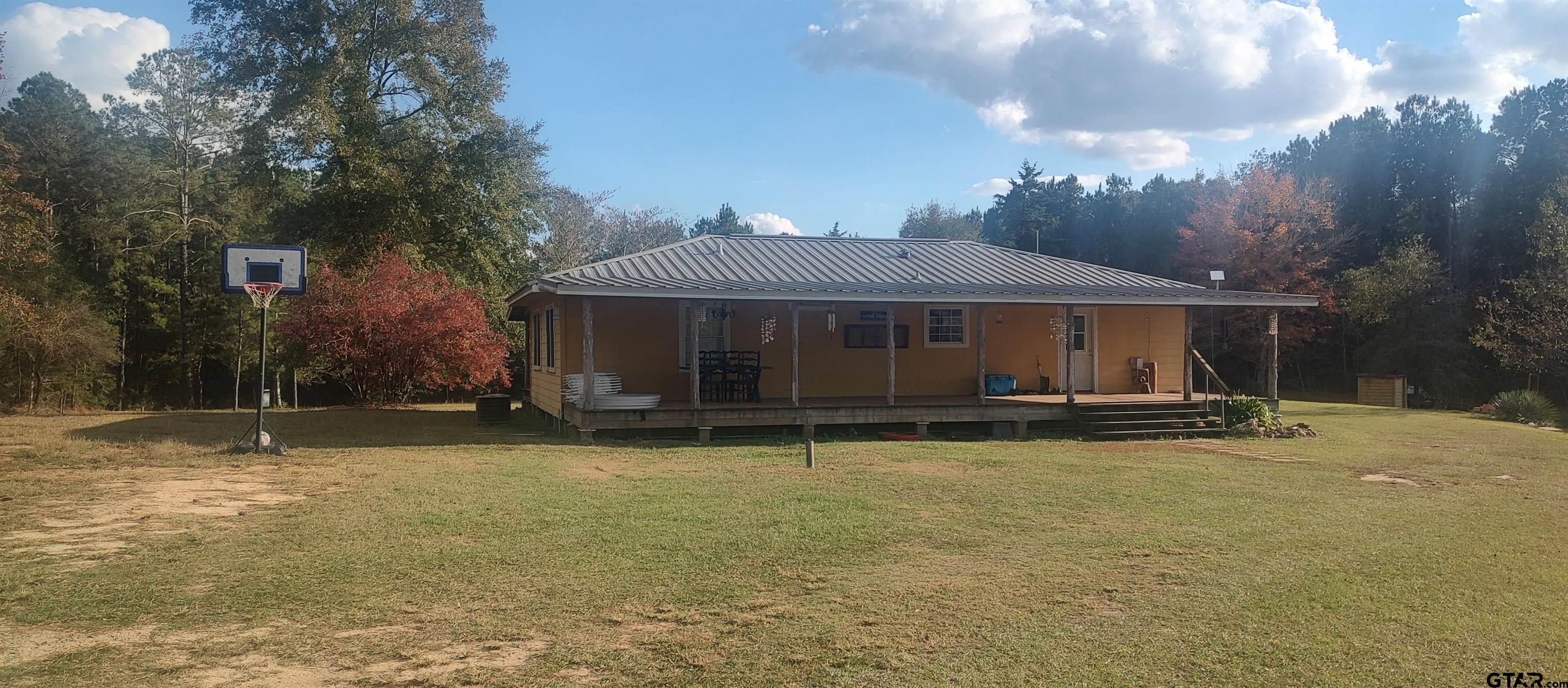 1271 County Road 3685 Joaquin, TX 75954 - Photo 25 of 46 a view of a house with swimming pool and a yard