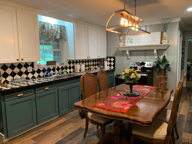 a kitchen with a table and chairs