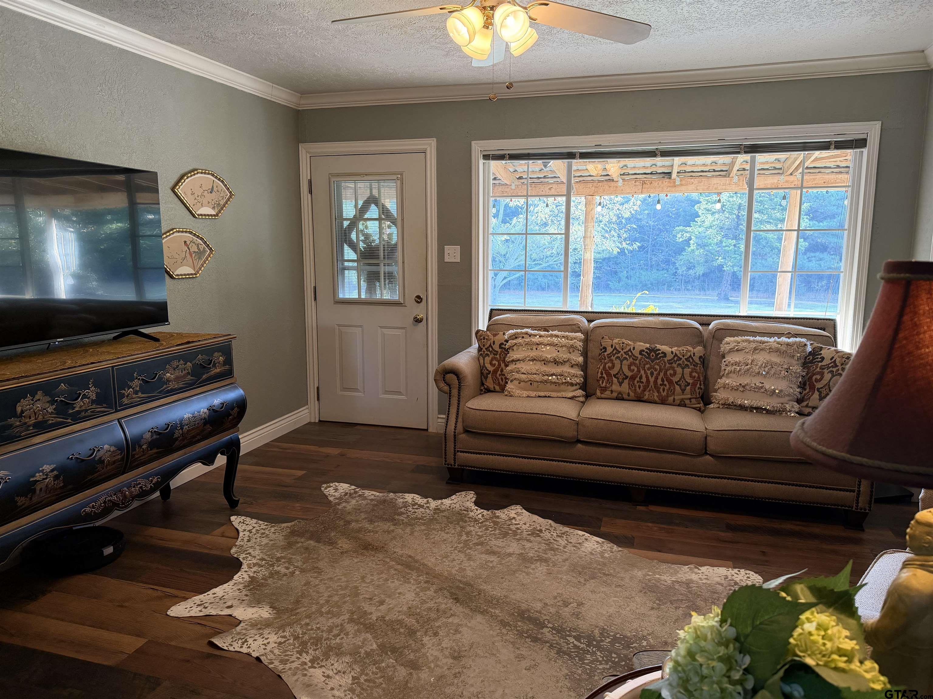 1271 County Road 3685 Joaquin, TX 75954 - Photo 36 of 46 a living room with furniture and a flat screen tv