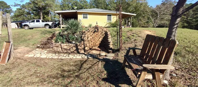 a backyard of a house with barbeque oven