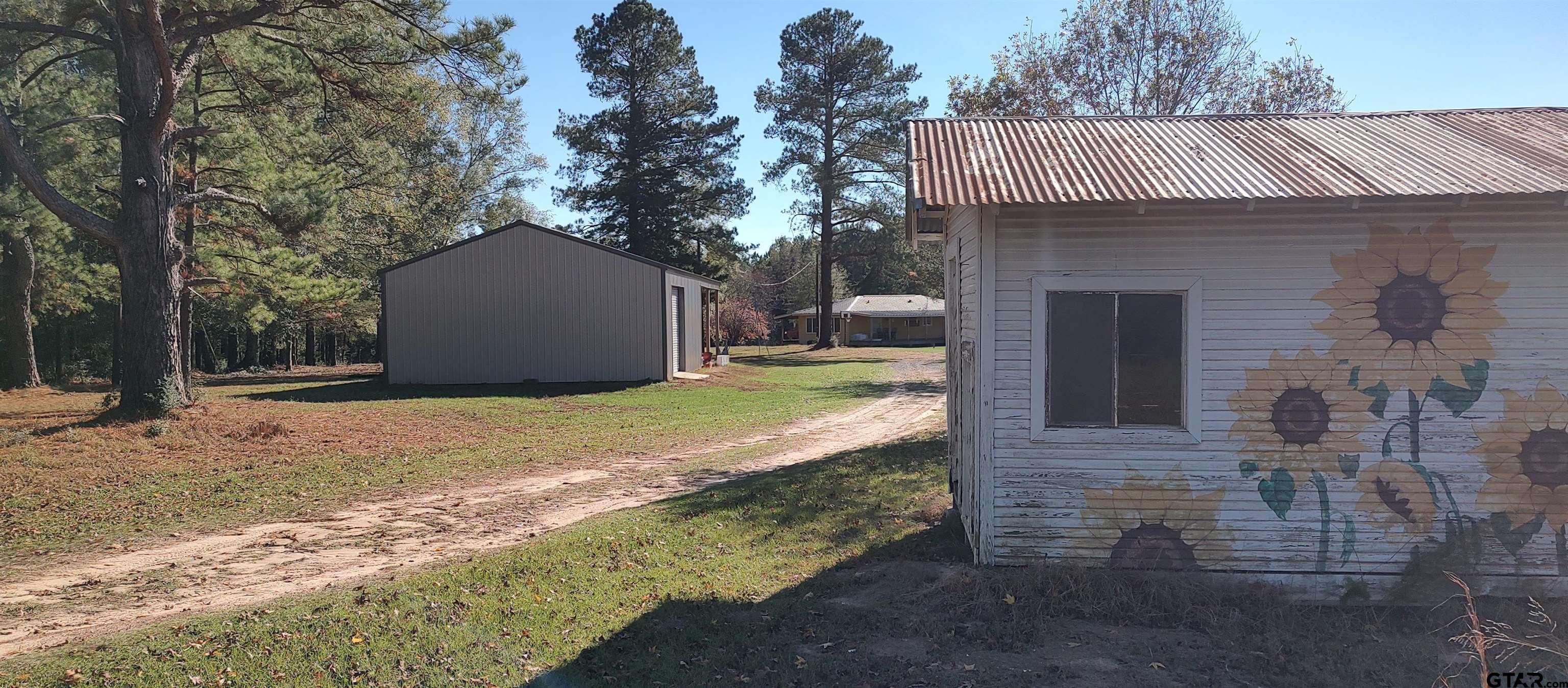 1271 County Road 3685 Joaquin, TX 75954 - Photo 46 of 46 a front view of a house with a yard and garage
