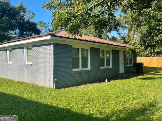 a front view of a house with a garden