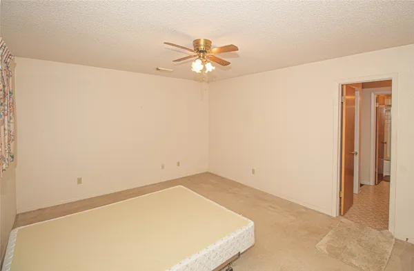 a view of a room with a ceiling fan