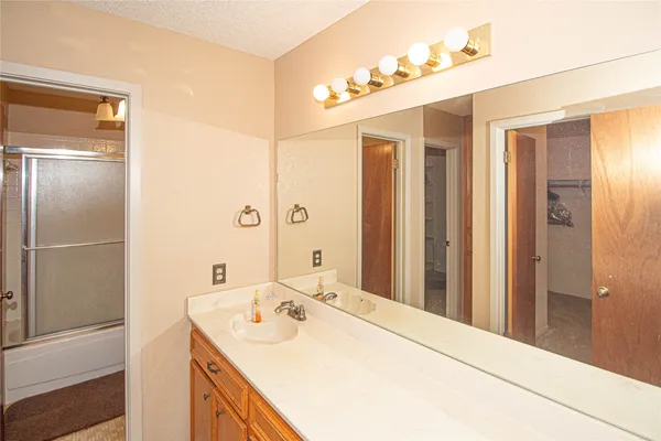 a room with a bed and a mirror