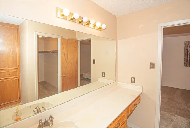 a bathroom with a shower and a sink