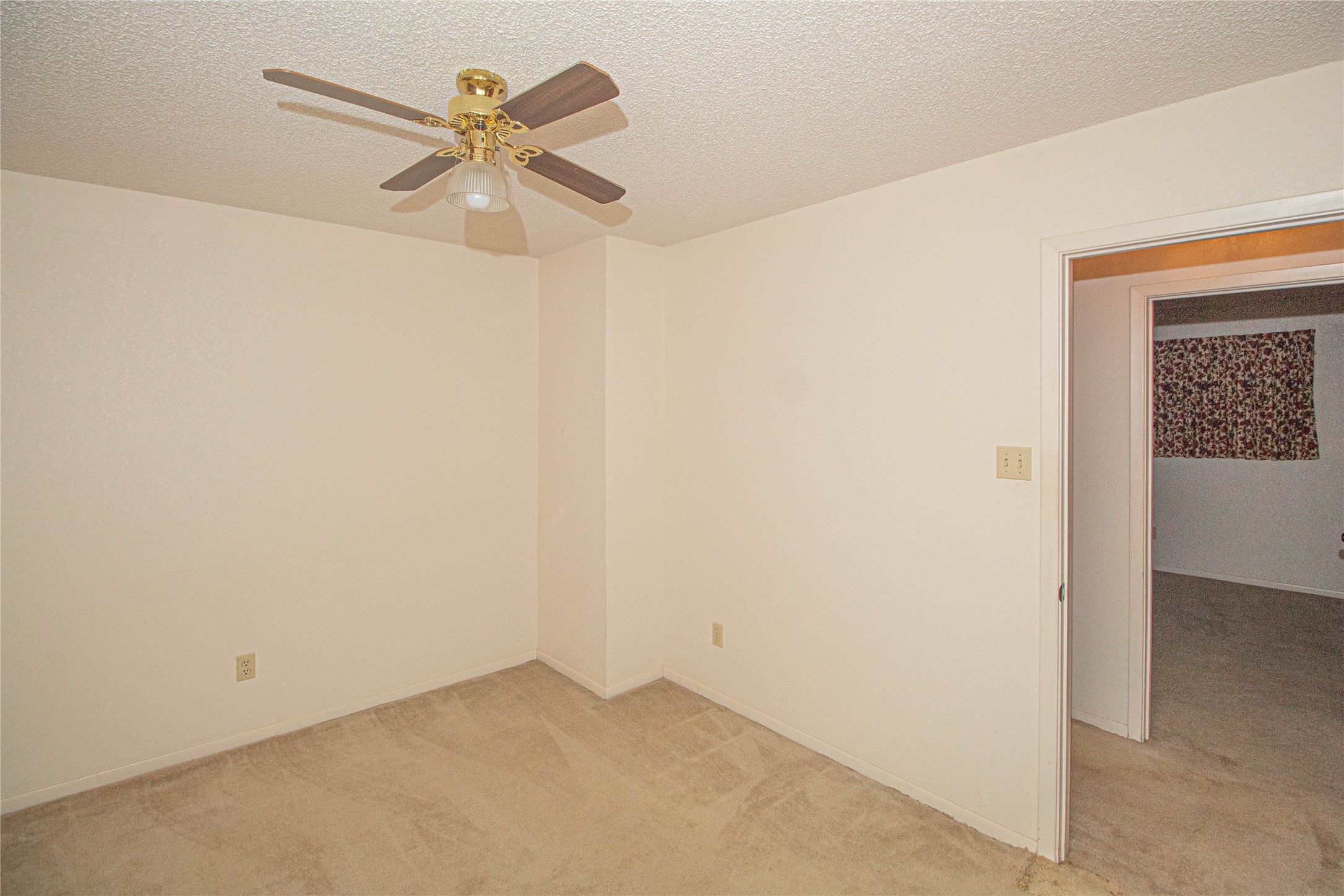 10500 Highway 150 Shepherd, TX 77371 - Photo 25 of 42 an empty room with a ceiling fan and a window