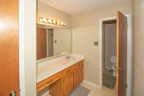 a bathroom with a toilet sink and shower