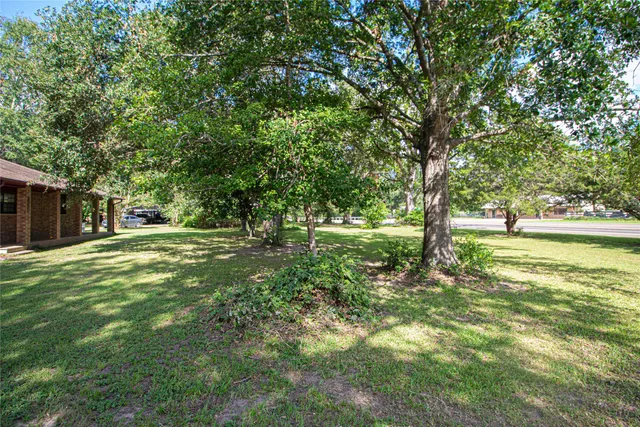 a view of yard with swimming pool and trees