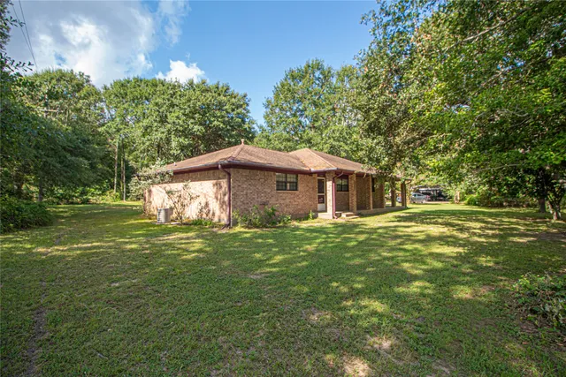 a view of a house with a tree in the yard