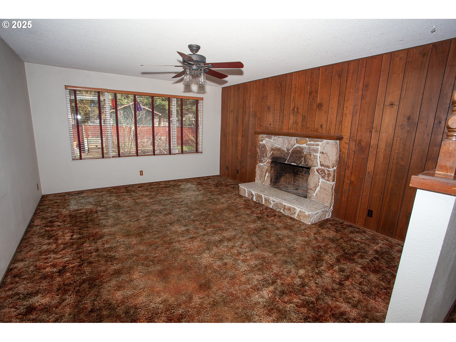 677 Laksonen Loop Springfield, OR 97478 - Photo 3 of 22 a view of an empty room with a fireplace and a window