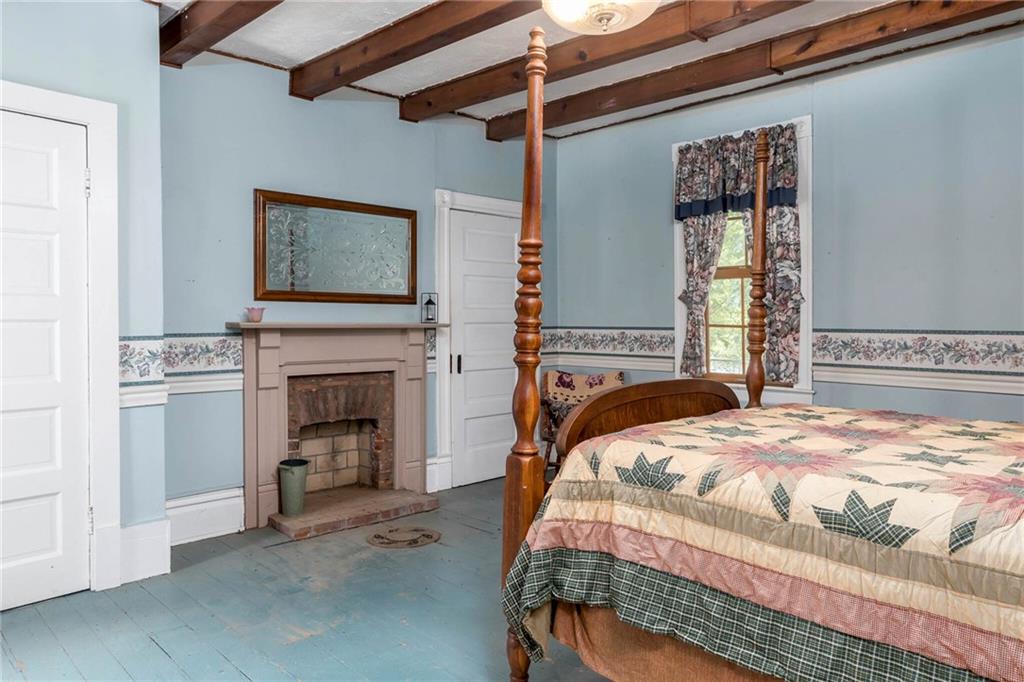 13 Penn Hill Road Prosperity, PA 15329 - Photo 21 of 30 a bedroom with a bed and a fireplace