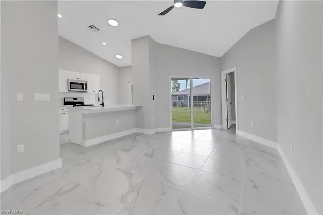 an empty room with entrance and windows