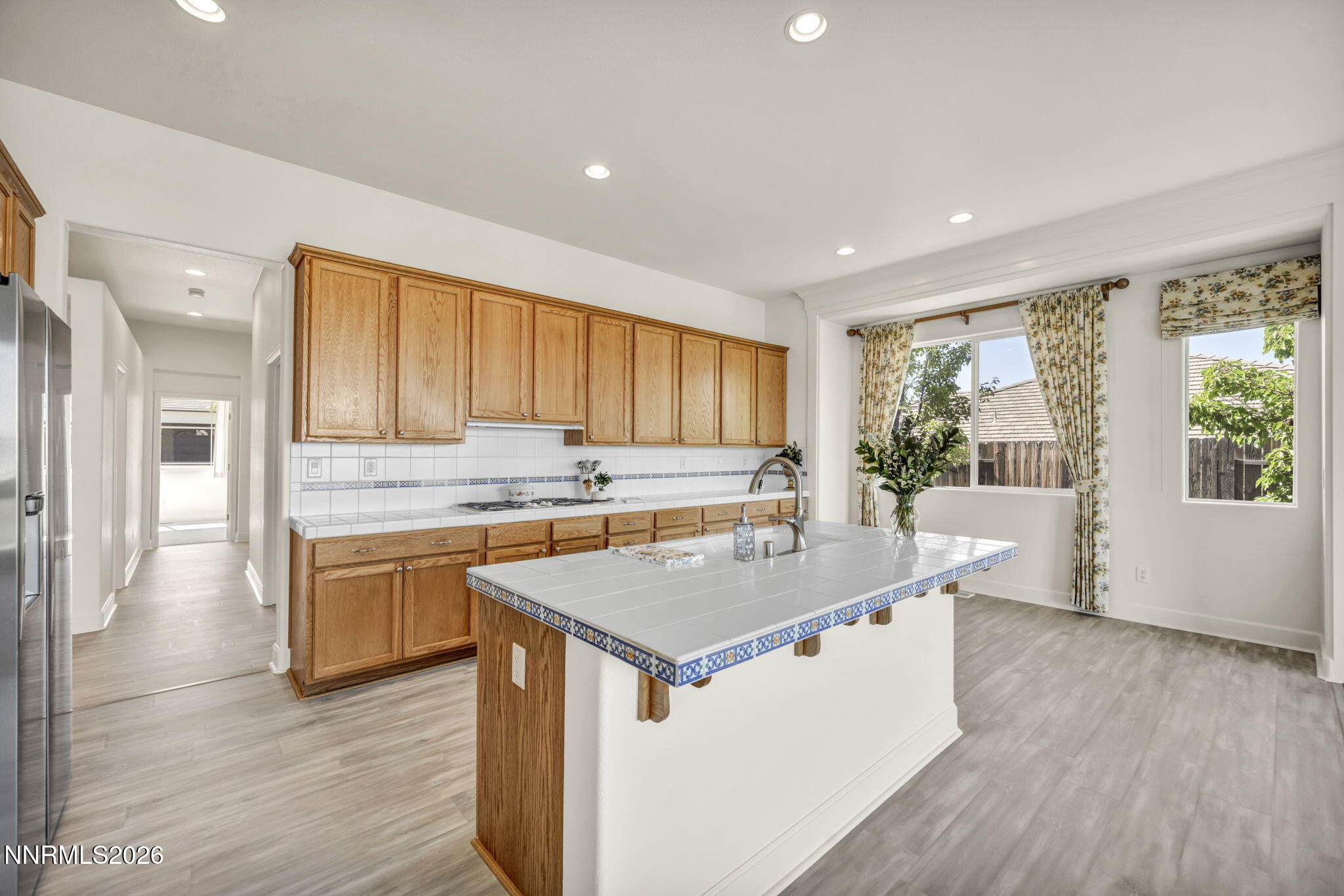 574 Echo Ridge Court Reno, NV 89511 - Photo 28 of 58 a kitchen with a stove a sink a refrigerator and wooden floor