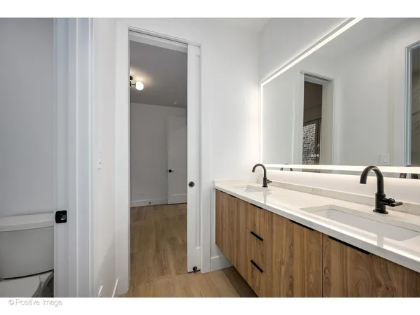 a bathroom with a double vanity sink and mirror