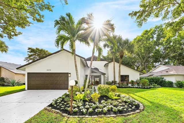 a front view of a house with a garden and entryway