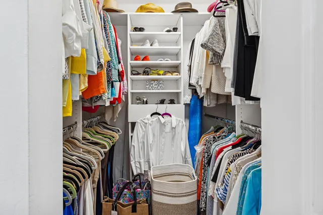 a bathroom with a granite countertop sink mirror vanity and toilet
