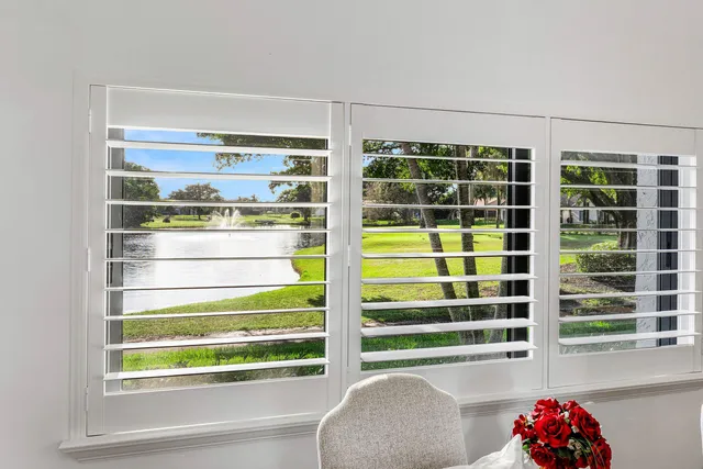 a view of a dining room with furniture wooden floor and a chandelier