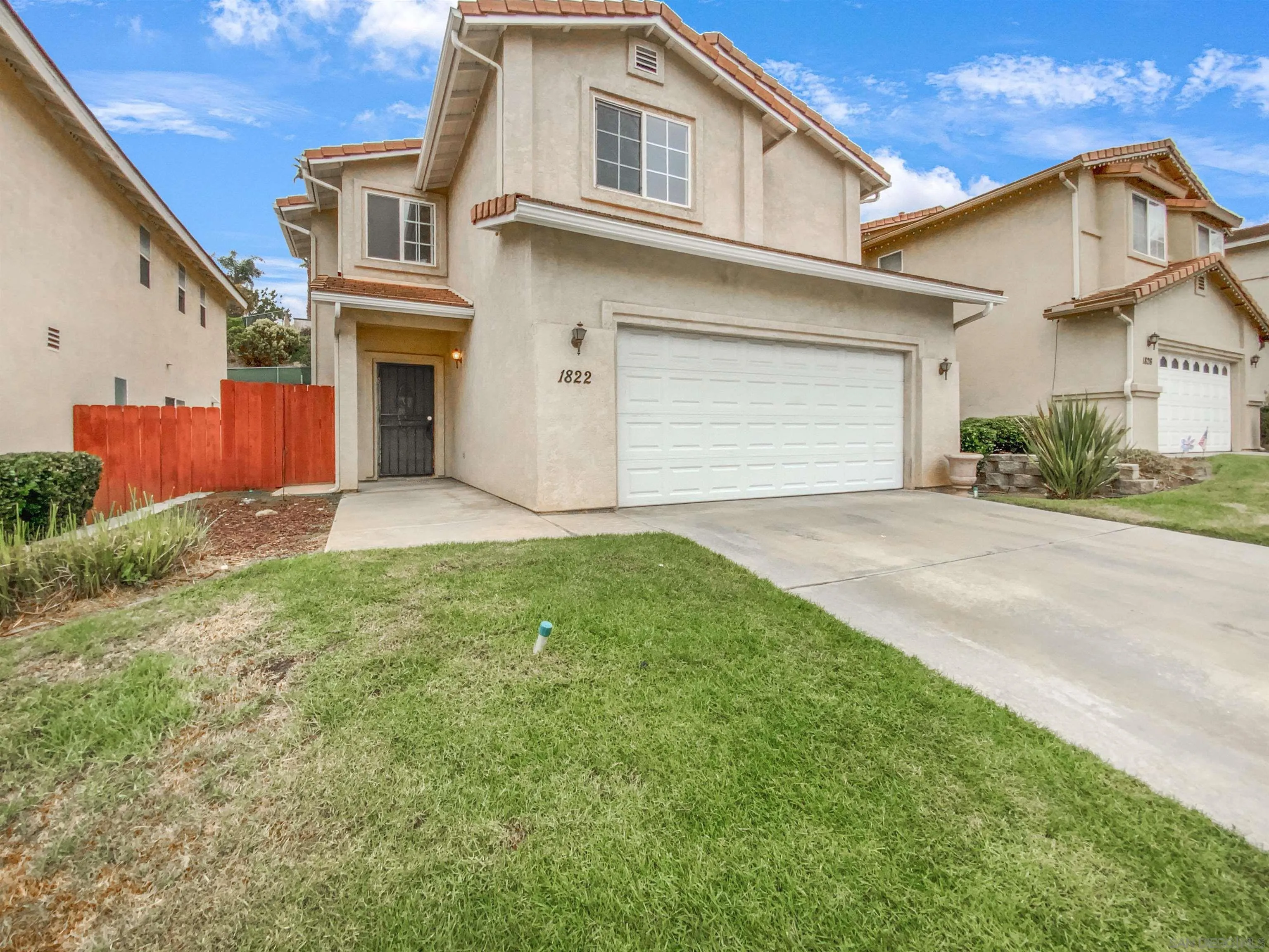 1822 McDougal Terrace El Cajon, CA 92021 - Photo 1 of 17 a front view of a house with a yard and garage