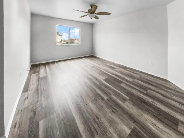 wooden floor in an empty room with a window
