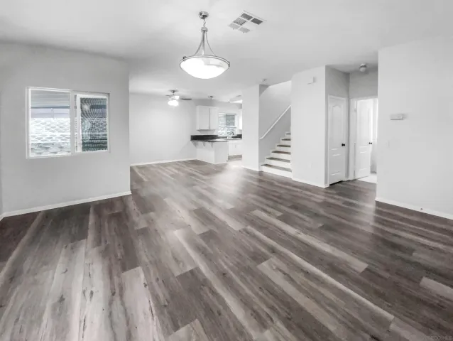 a view of kitchen and hall with wooden floor