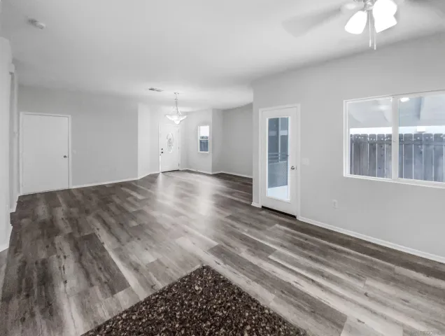 a view of a room with wooden floor and white walls