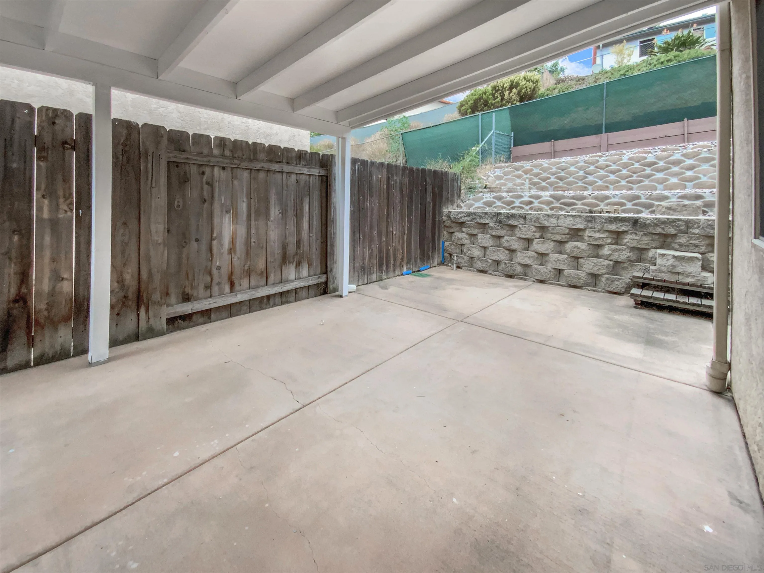 1822 McDougal Terrace El Cajon, CA 92021 - Photo 8 of 17 a view of backyard with sliding door and wooden floor
