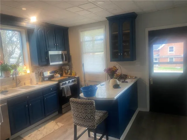 a kitchen with granite countertop a sink stove and refrigerator