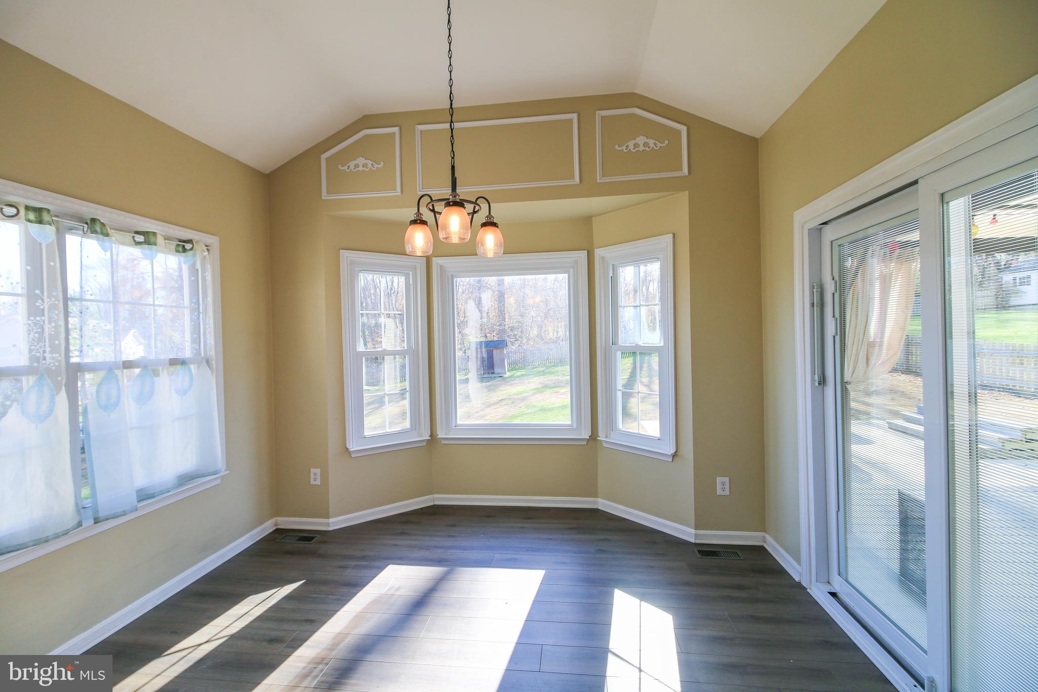 56 Cross Point Drive Owings, MD 20736 - Photo 11 of 54 a view of an empty room with wooden floor and a window
