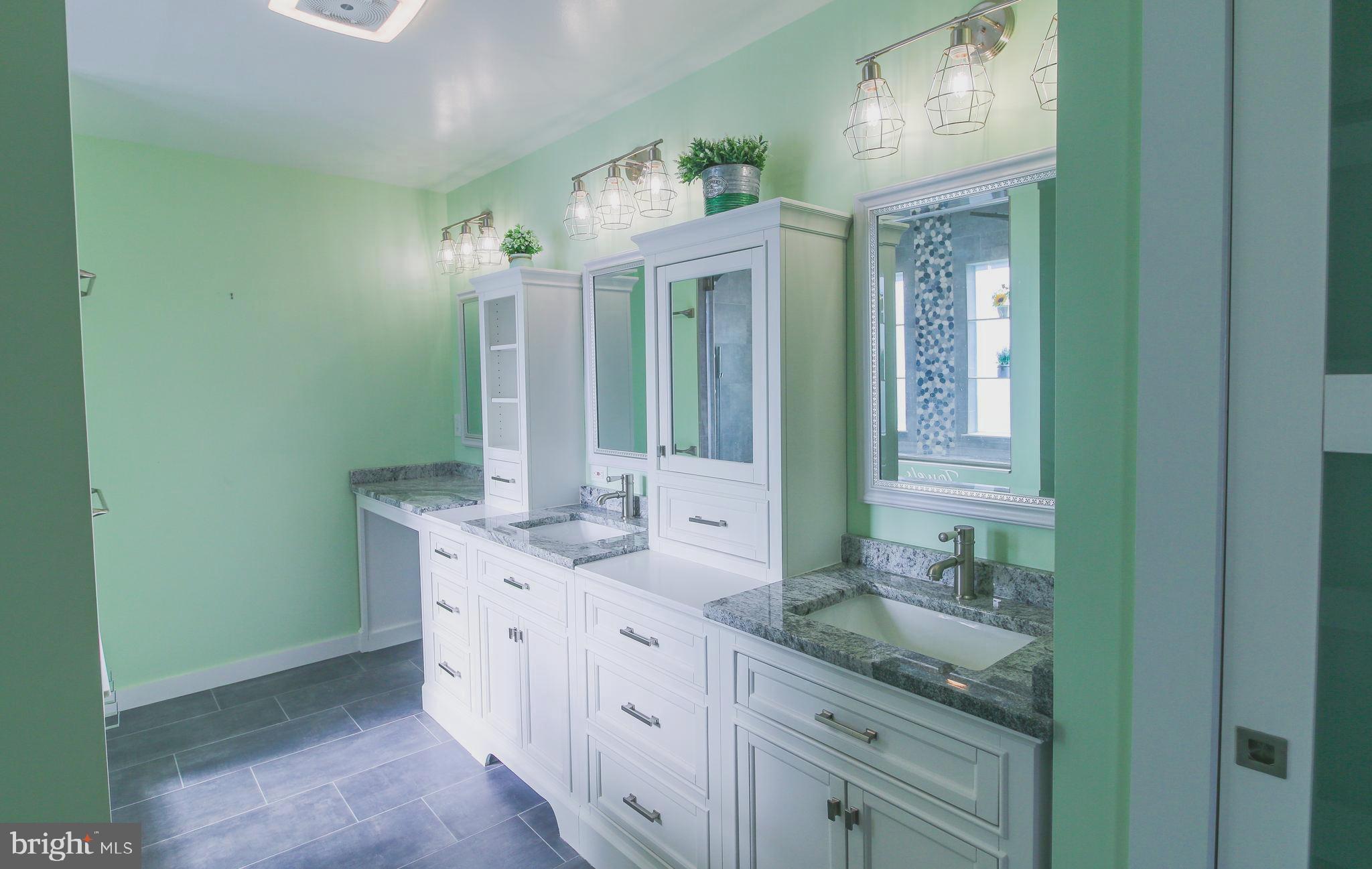 56 Cross Point Drive Owings, MD 20736 - Photo 17 of 54 a spacious bathroom with a double vanity sink and a mirror
