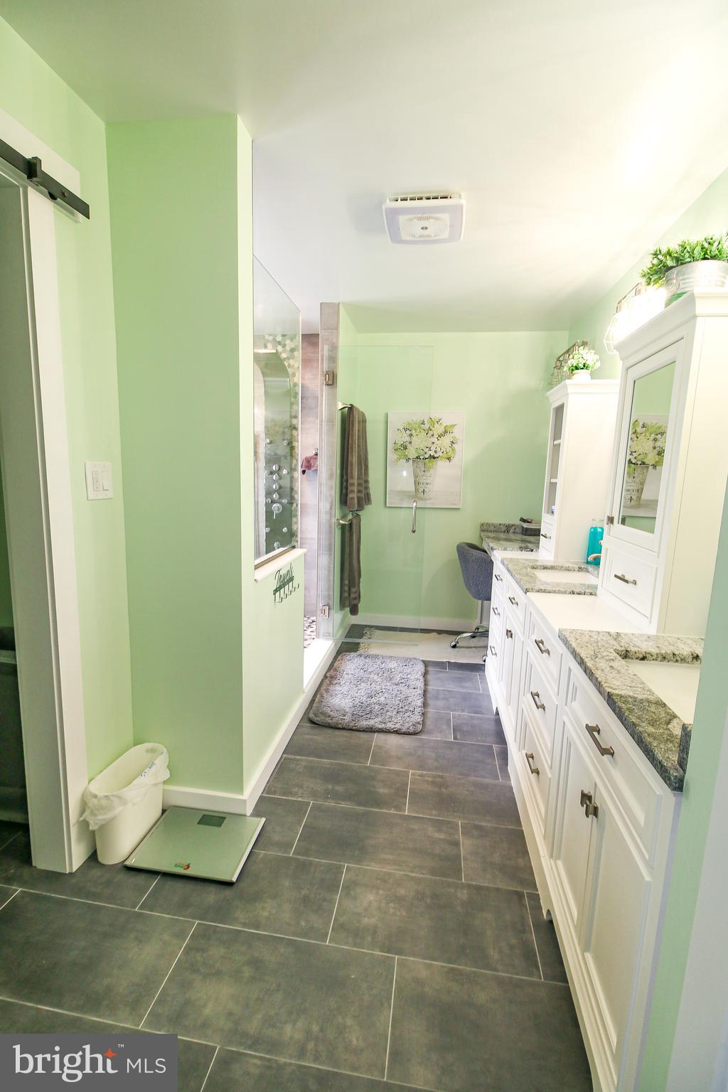 56 Cross Point Drive Owings, MD 20736 - Photo 19 of 54 a bathroom with a granite countertop sink and a mirror