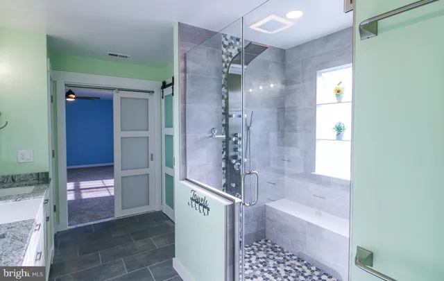 a bathroom with a shower and a sink