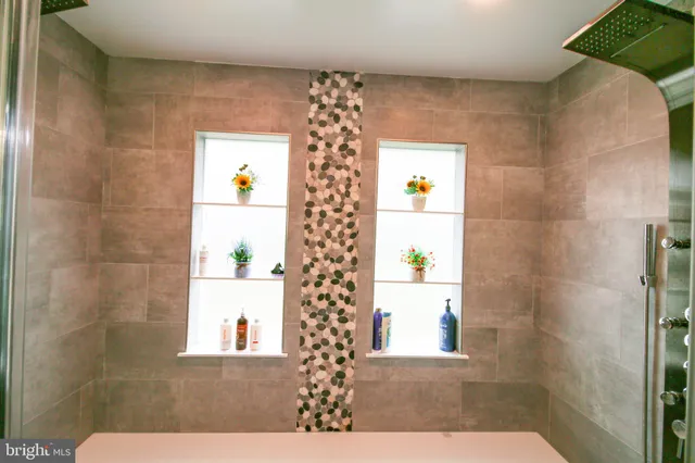 a bathroom with a shower and a sink