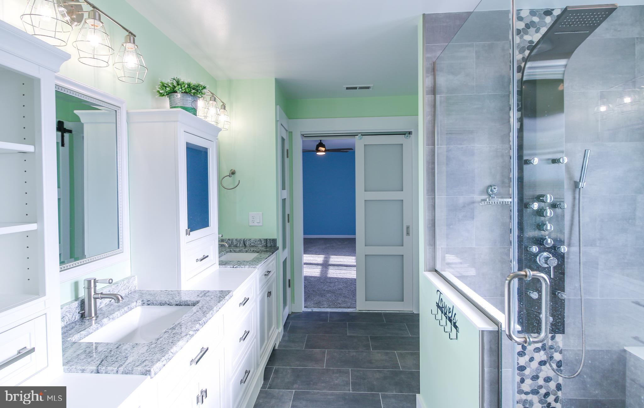 56 Cross Point Drive Owings, MD 20736 - Photo 24 of 54 a bathroom with a granite countertop double vanity sink a mirror and a shower