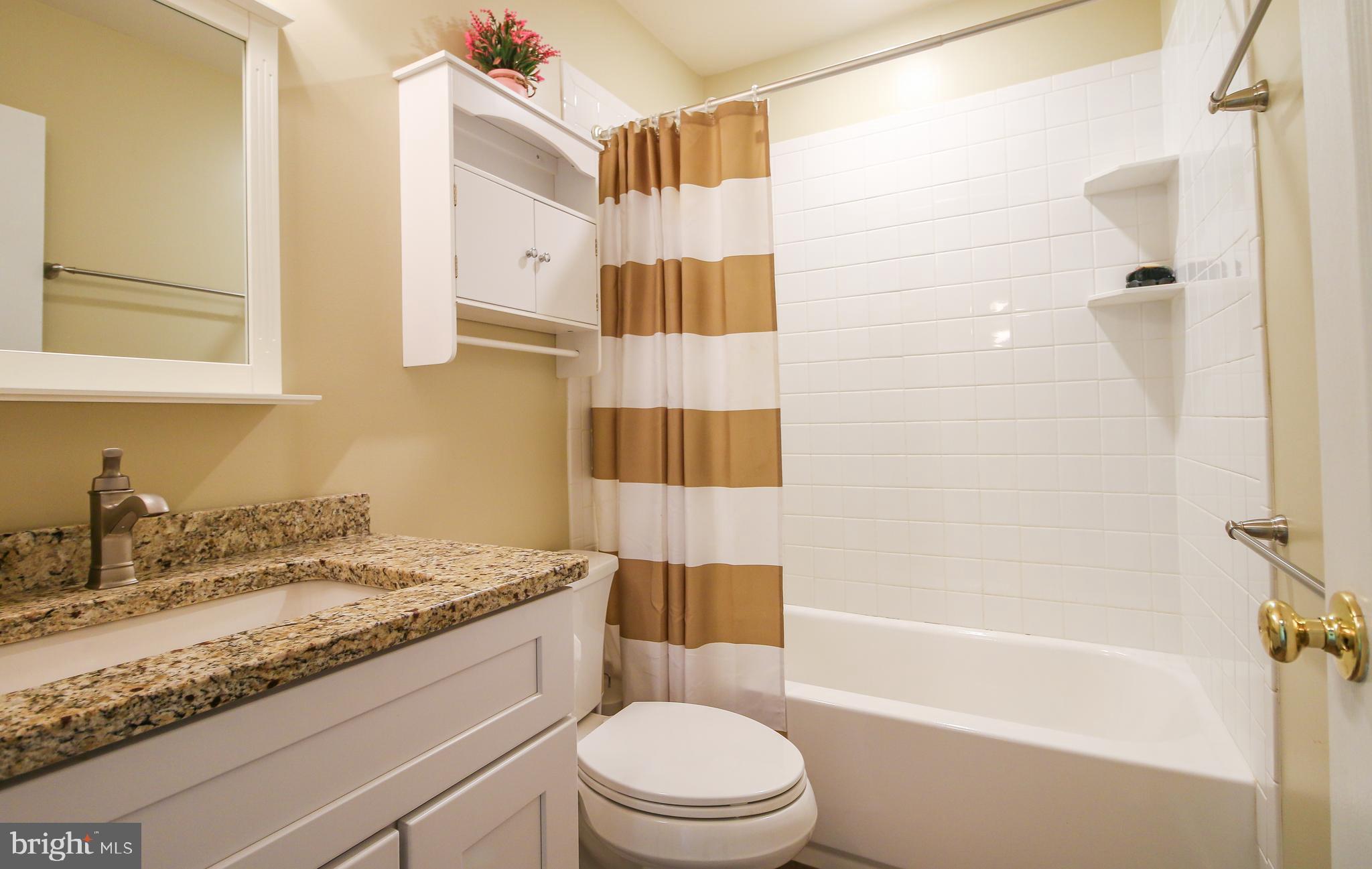 56 Cross Point Drive Owings, MD 20736 - Photo 26 of 54 a bathroom with a granite countertop sink toilet and shower