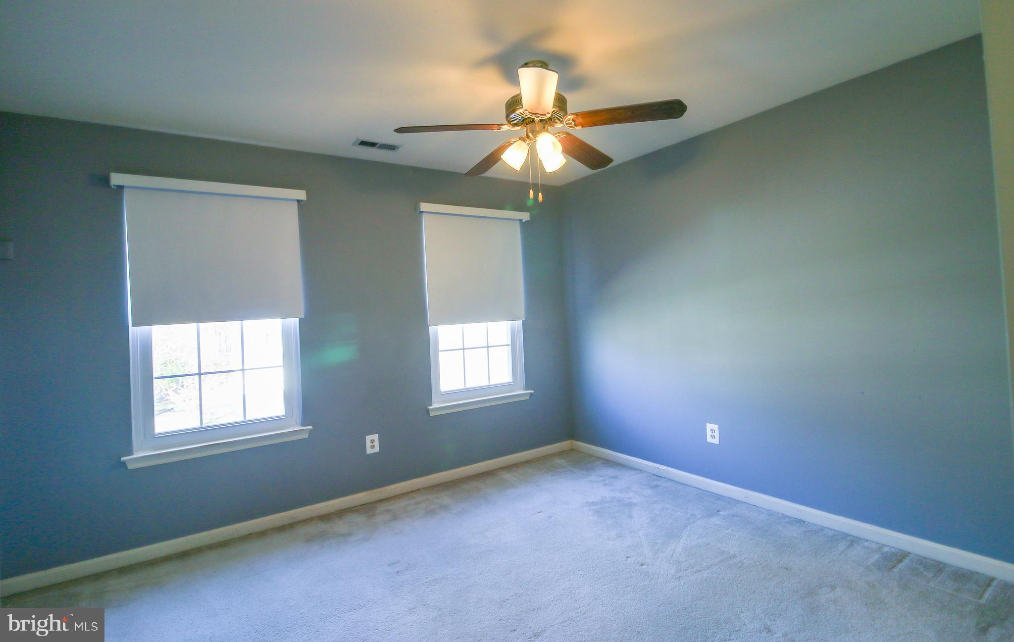 56 Cross Point Drive Owings, MD 20736 - Photo 28 of 54 an empty room with windows and fan