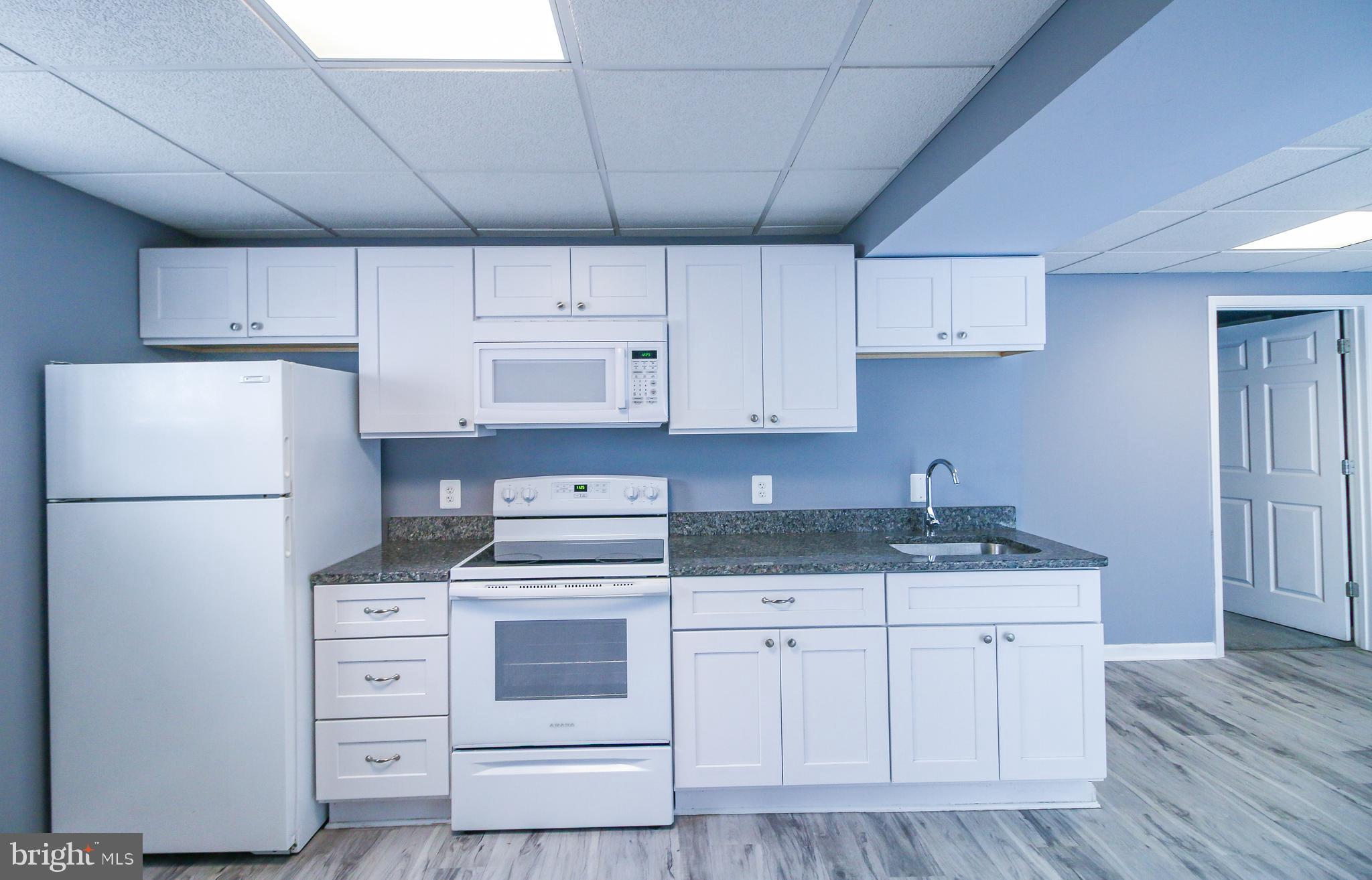 56 Cross Point Drive Owings, MD 20736 - Photo 38 of 54 a kitchen with cabinets appliances a sink and a counter top space