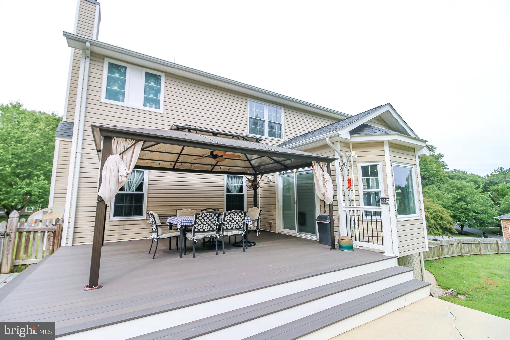 56 Cross Point Drive Owings, MD 20736 - Photo 45 of 54 a view of a patio with table and chairs with wooden floor and fence