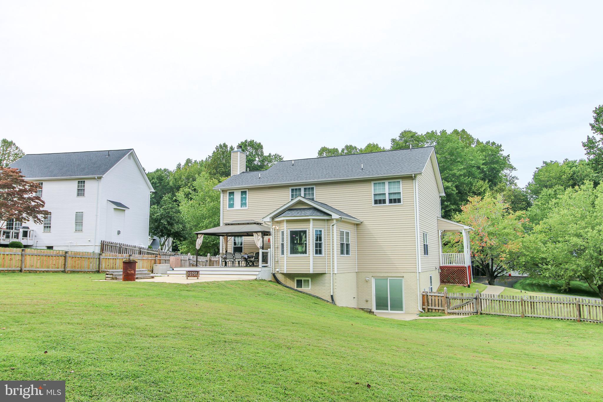 56 Cross Point Drive Owings, MD 20736 - Photo 49 of 54 a front view of a house with a garden and trees