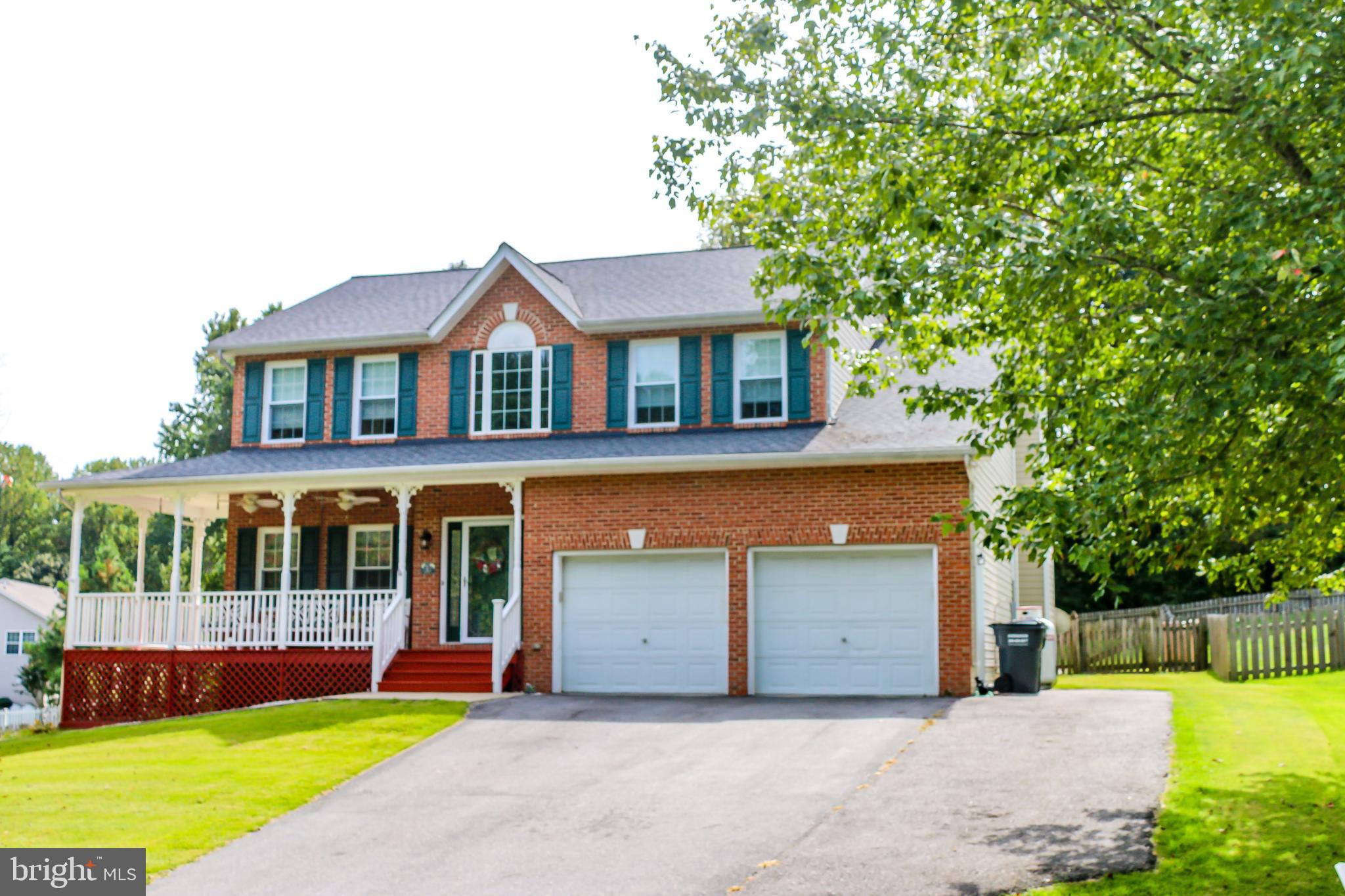 56 Cross Point Drive Owings, MD 20736 - Photo 54 of 54 a front view of a house with a yard and potted plants