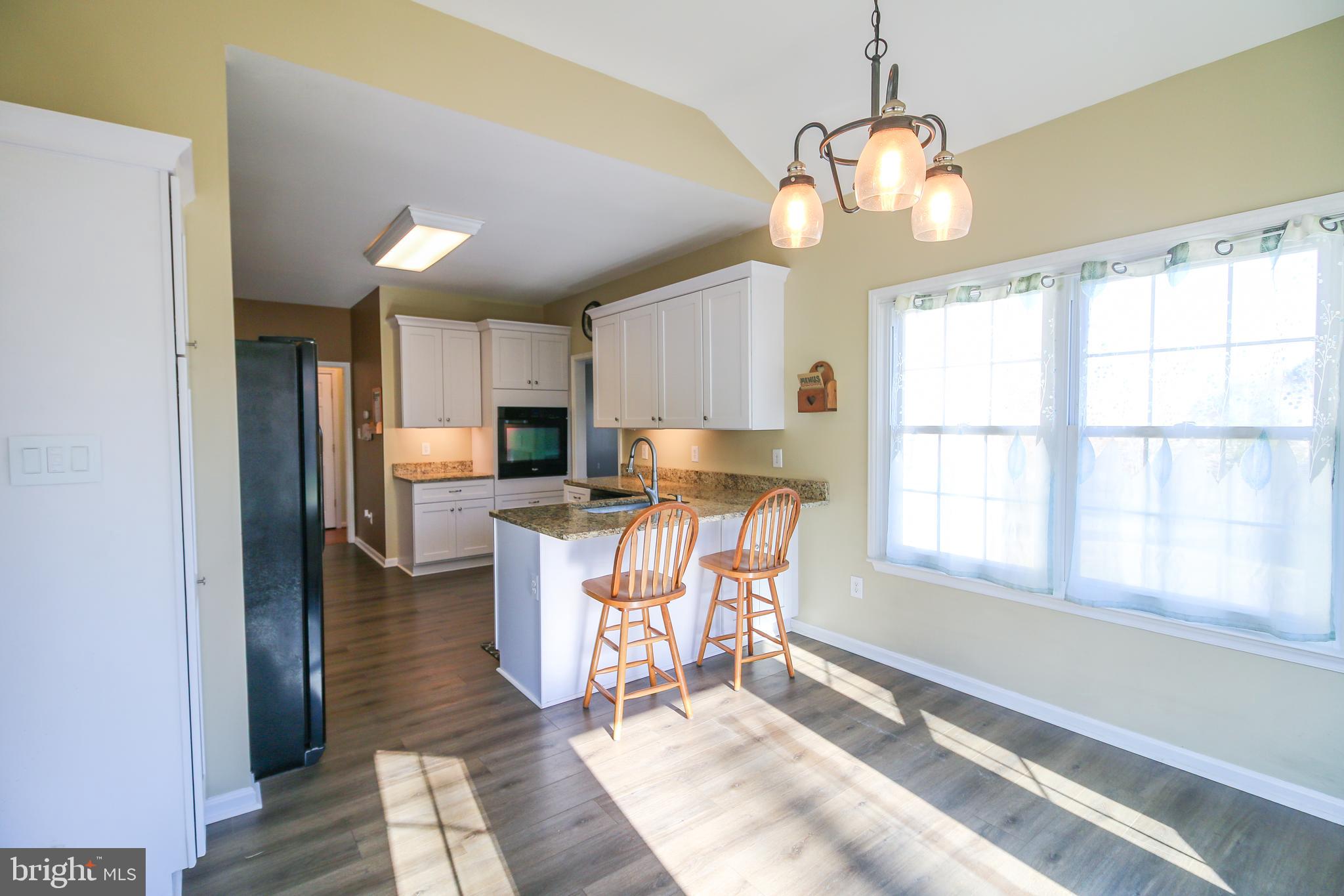 56 Cross Point Drive Owings, MD 20736 - Photo 10 of 54 a view of a dining room with furniture window and wooden floor