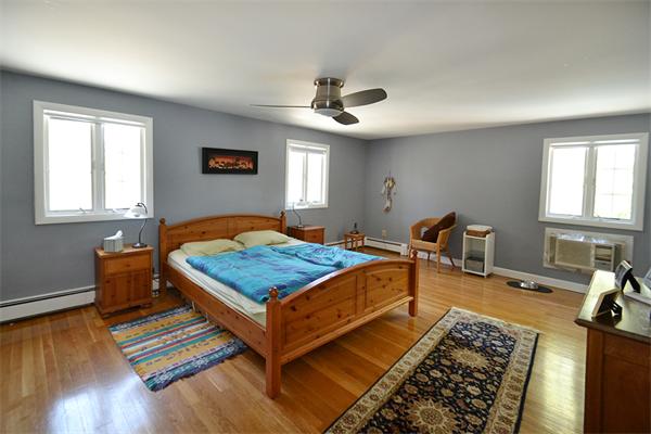 236 Parish Road Needham, MA 02494 - Photo 11 of 23 a bedroom with a bed and wooden floor
