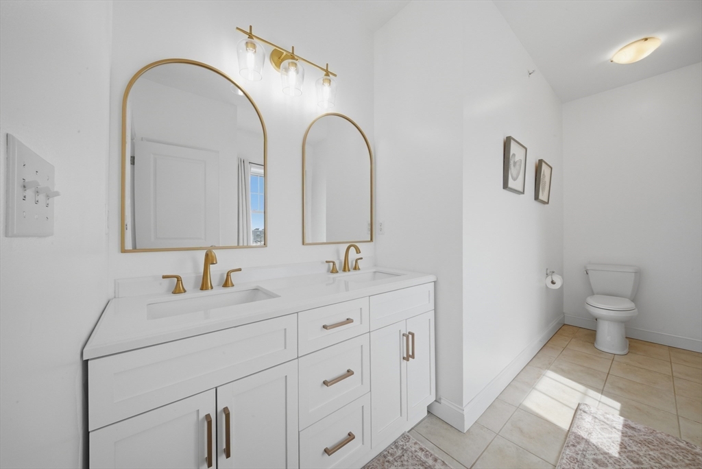 233 Beach Road, Unit A11 Salisbury, MA 01952 - Photo 26 of 37 a bathroom with 2 sink toilet and a mirror