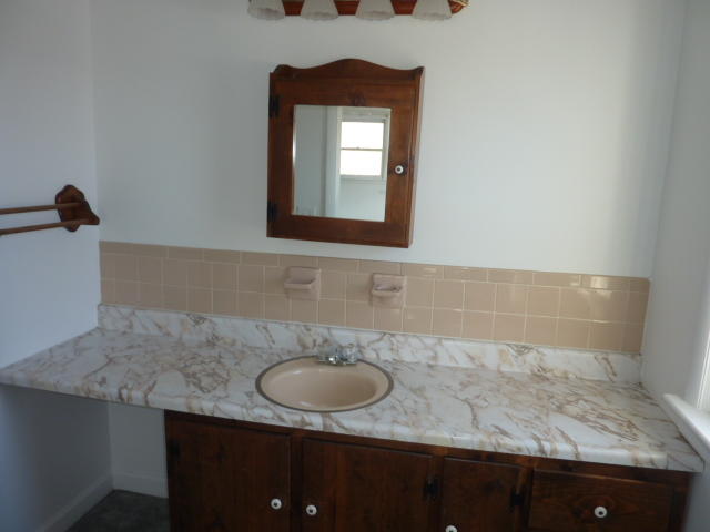 9700 Roanoke Road Elliston, VA 24087 - Photo 12 of 28 a bathroom with a granite countertop sink a mirror and vanity