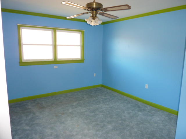 9700 Roanoke Road Elliston, VA 24087 - Photo 14 of 28 an empty room with windows and chandelier fan