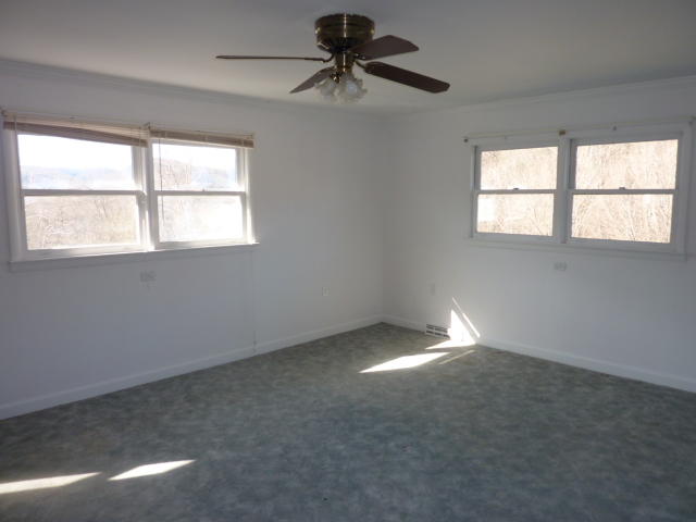 9700 Roanoke Road Elliston, VA 24087 - Photo 18 of 28 an empty room with a window and a fan