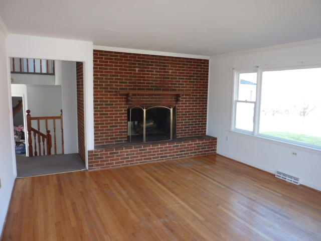 9700 Roanoke Road Elliston, VA 24087 - Photo 4 of 28 a view of empty room with wooden floor and a fireplace
