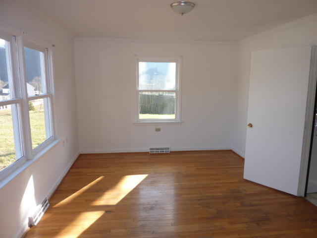 9700 Roanoke Road Elliston, VA 24087 - Photo 5 of 28 a view of an empty room with wooden floor and a window